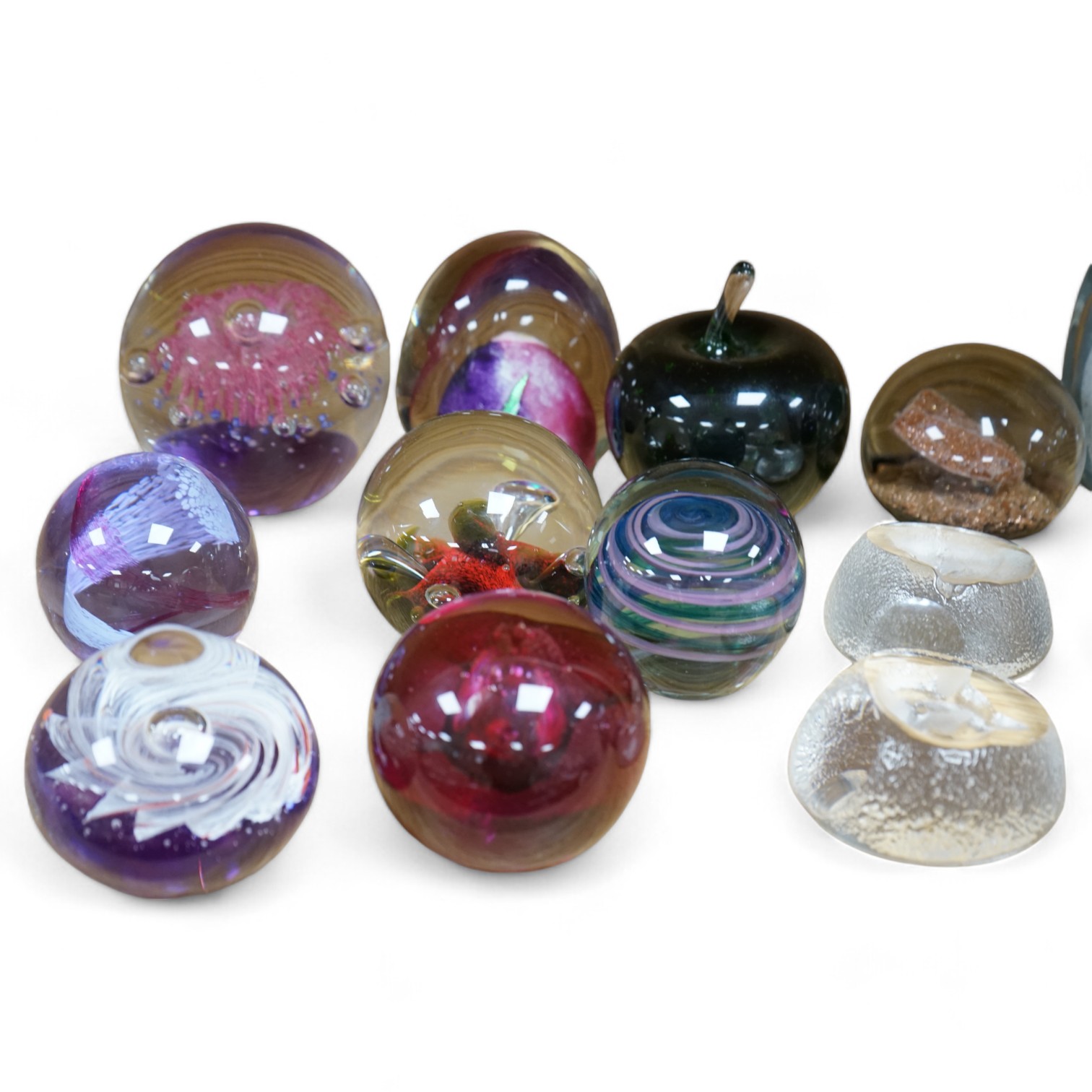 Twenty three glass paperweights, including five with silhouettes of animals, and others of unusual shape. Condition - good